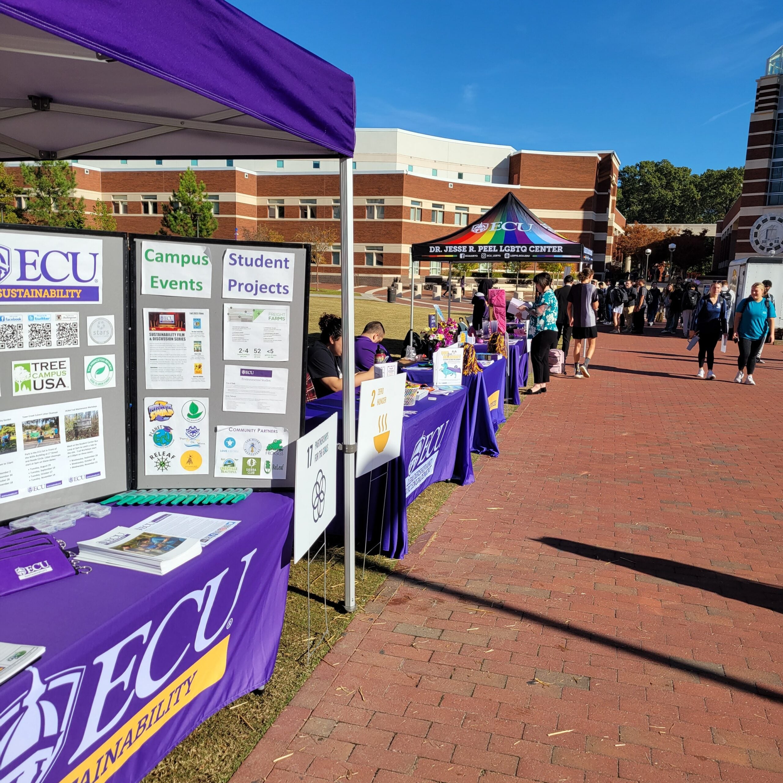 A row of tables with representative from several organizations around campus for Campus Sustainability Day