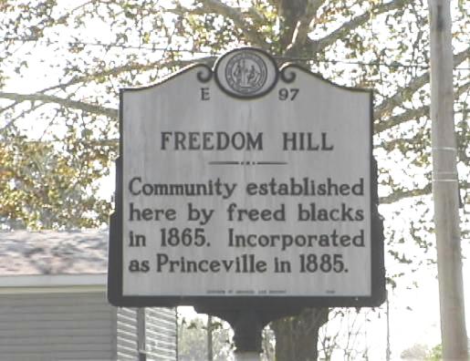 A sign that says "Freedom Hill community established by free blacks in 1865. Incorporated as Princeville in 1885."