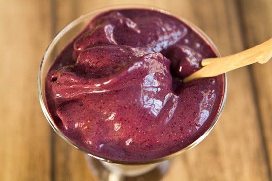 a purple berry sorbet with a wooden spoon