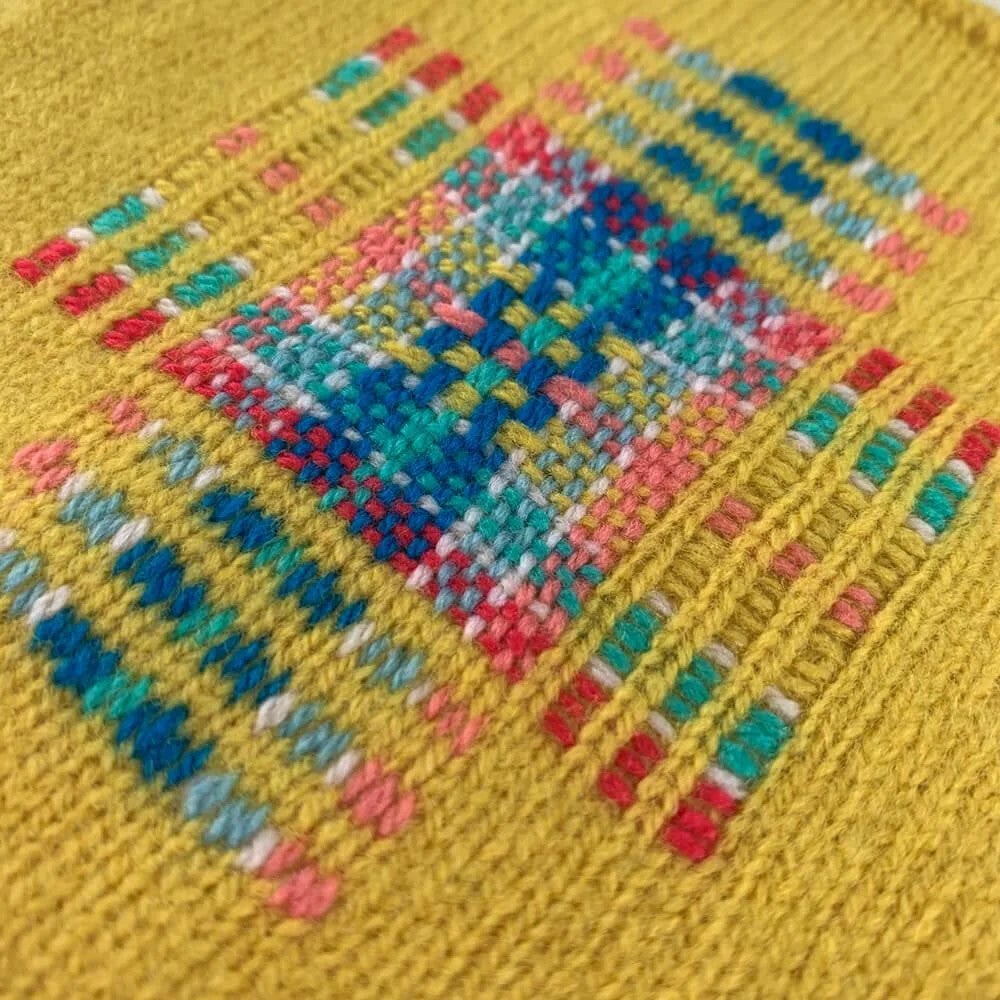 A mended patch of cloth with a colorful patchwork design